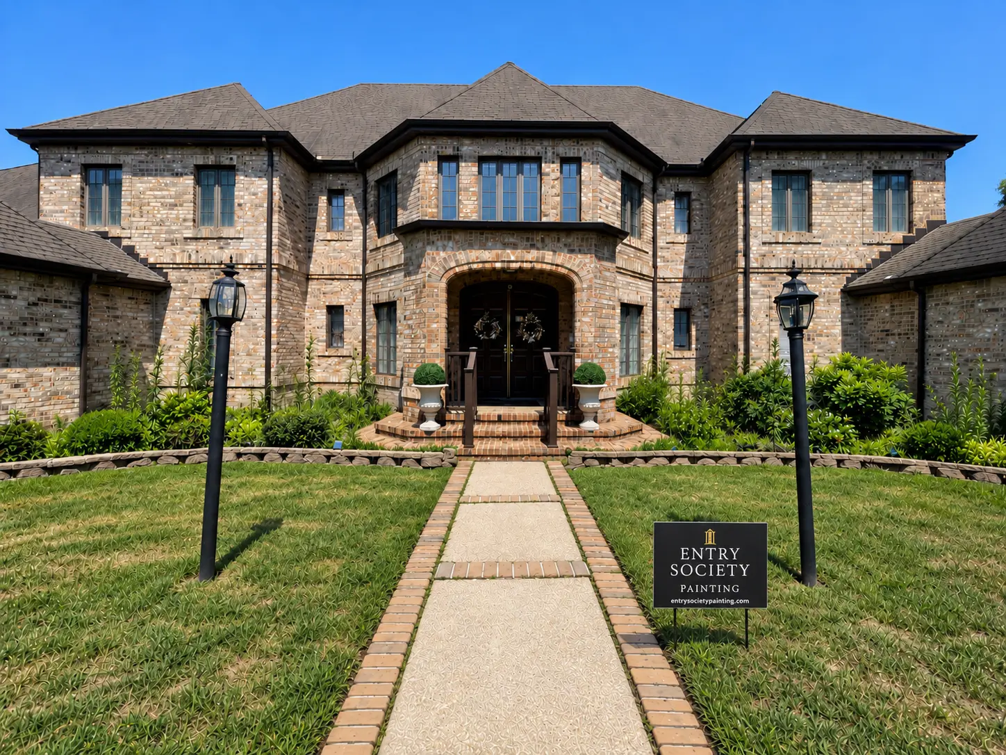 Brick home with refinished front entry and Entry Society Painting yard sign on the lawn